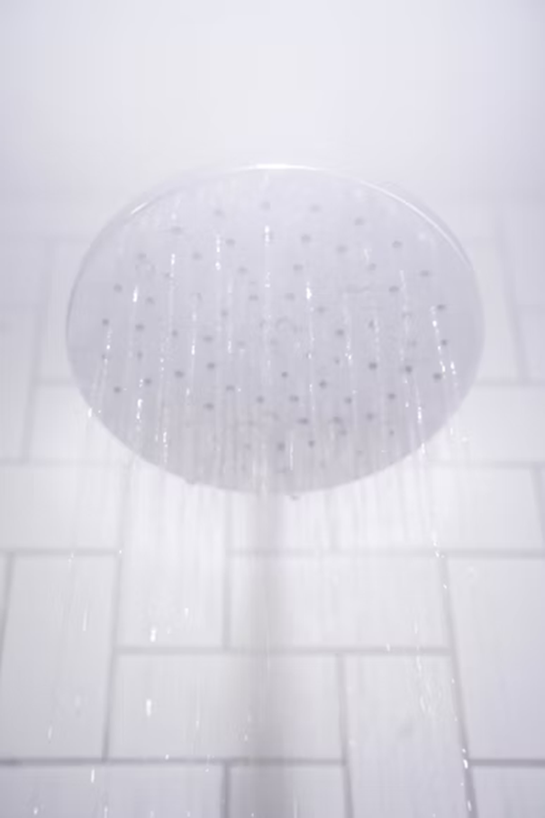 shower head and steam in bathroom