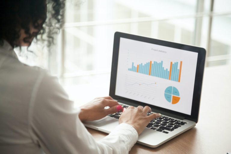 businesswoman analyzing project statistics on laptop screen, close up