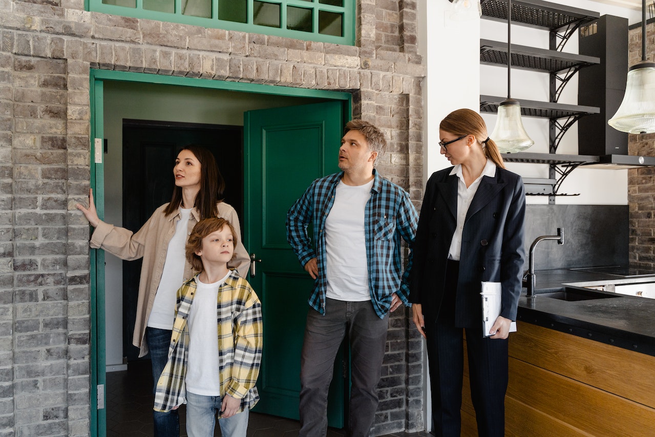 a family at an open house with a realtor