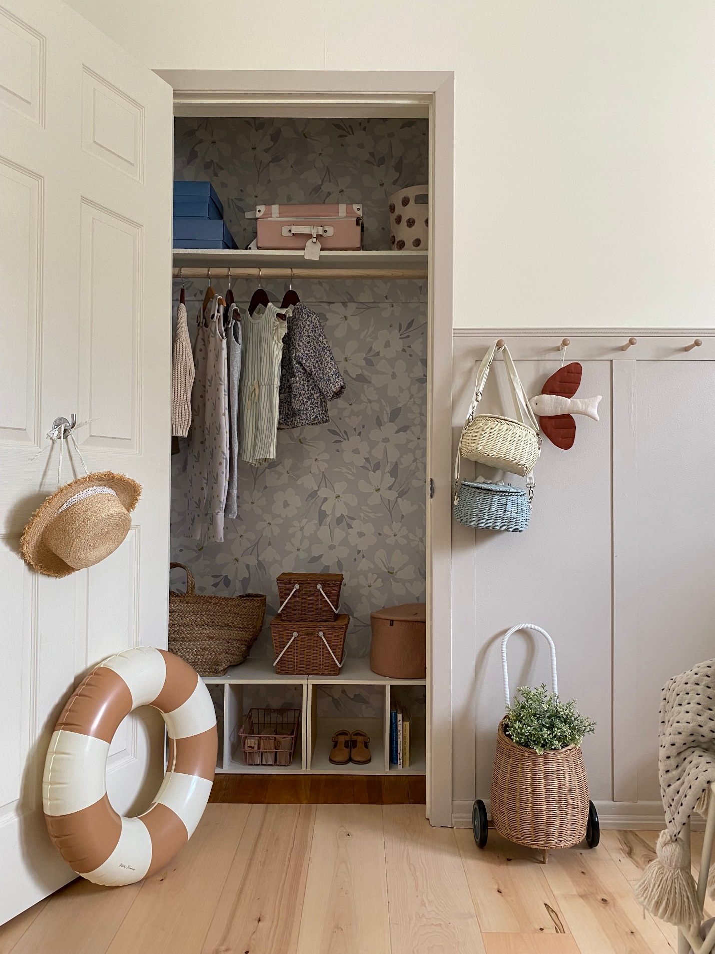 A closet with clothes and baskets Description automatically generated